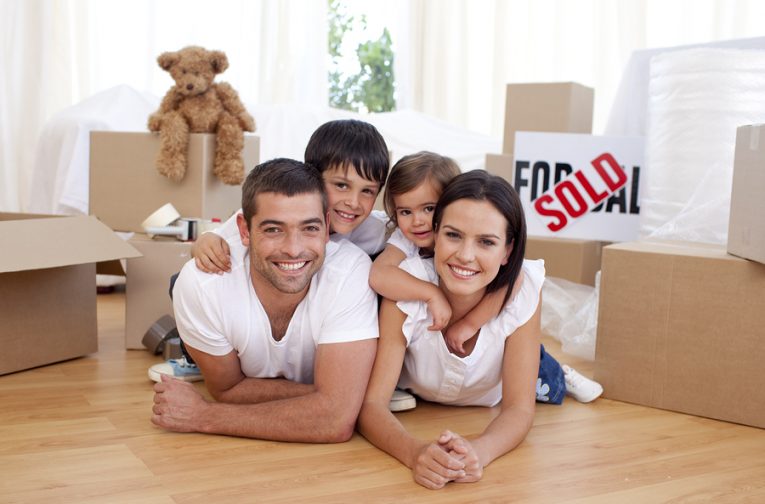 Happy family lying on floor after buying new house topics to address with realtor