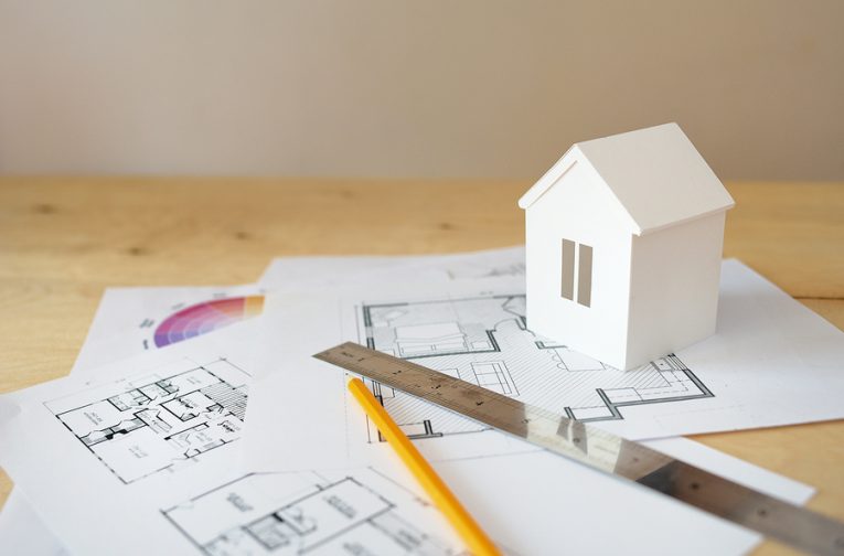 blueprints and house figurine should you remodel projects that hurt home value